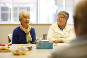 Two people take part in a discussion in the Library's meeting room (Links to Meetng Spaces information)