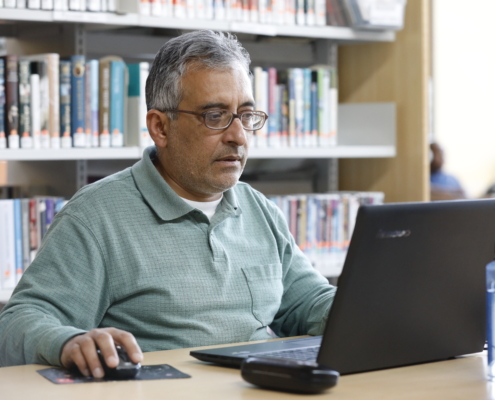 Person working on laptop in the library