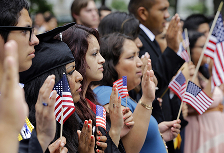 Group of people with American flags taking the final step to citizenship (Links to citizenship and immigration resources)