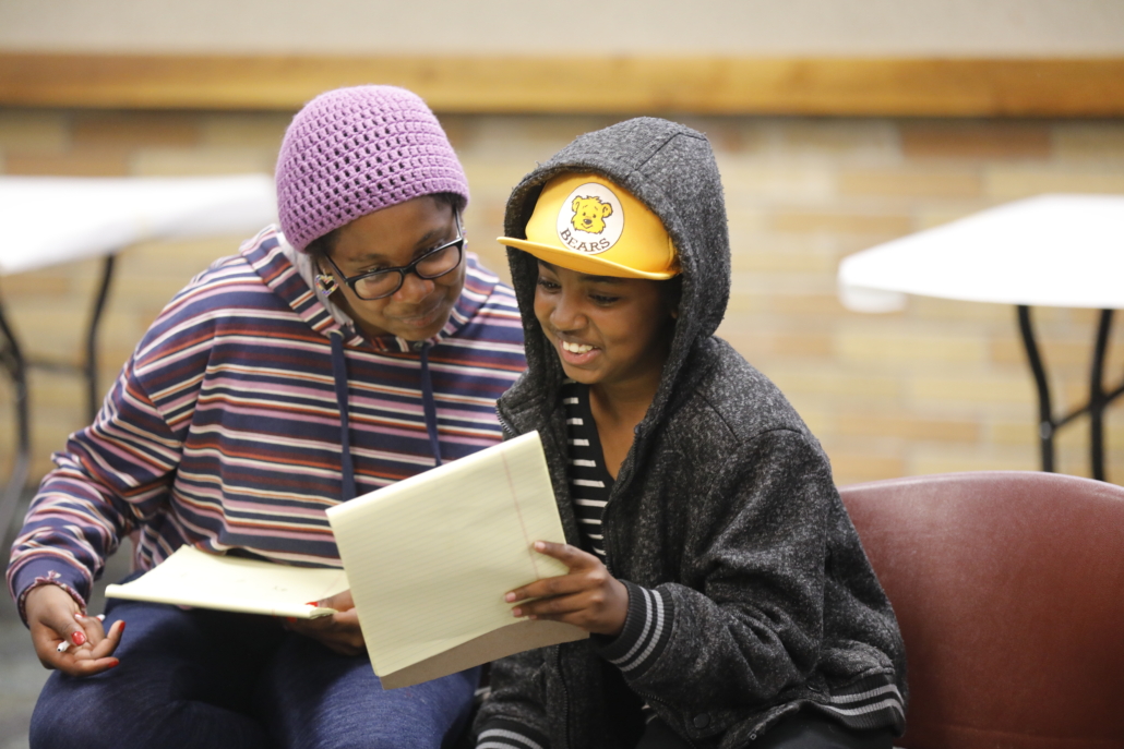 Two teens take part in a library art program