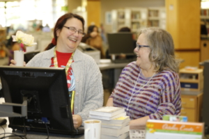 Two librarians enjoying their work at the library