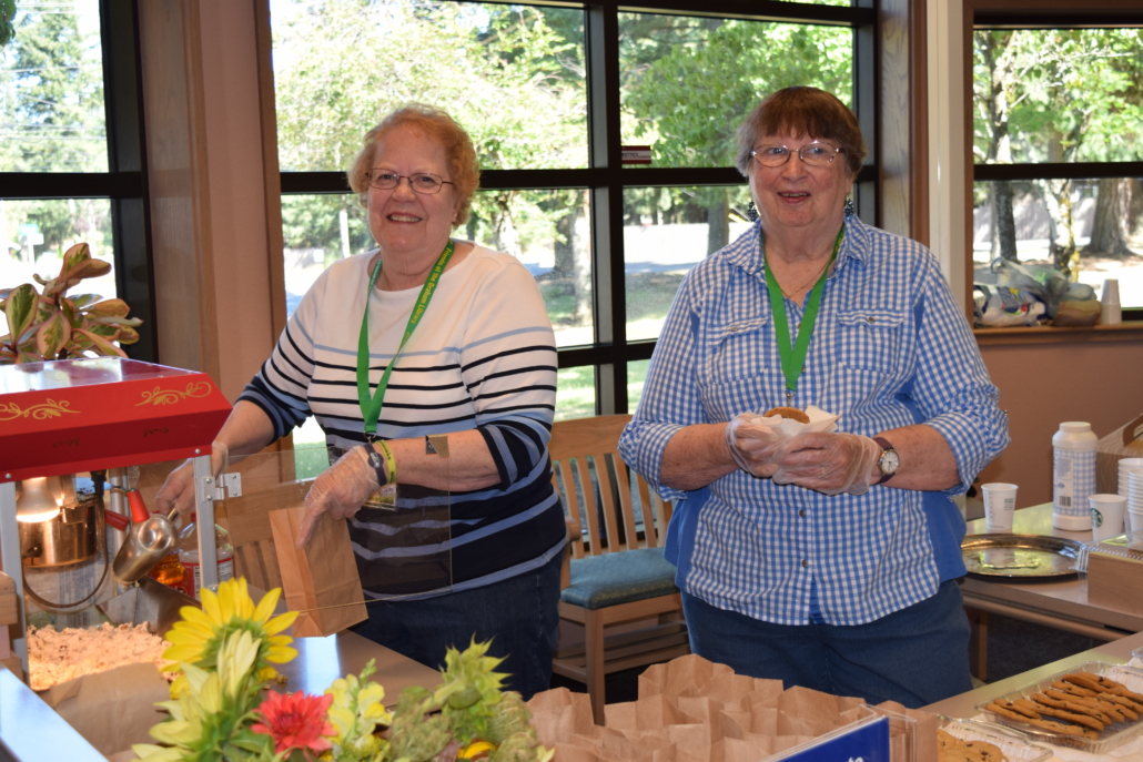Two members of the Friends of the Library serve snacks at a recent event (Links to Friends of the Library web page)