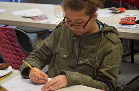 Teen works on drawing for the Our Own Expression Teen Art and Writing contest (Links to Contest page)