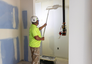 Worker painting walls