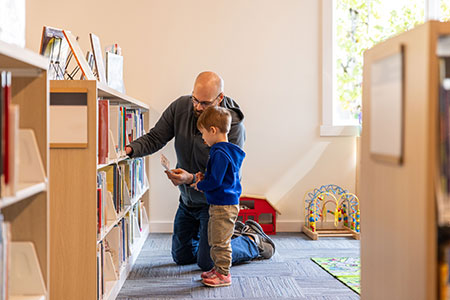 Adult and child enjoy the children's area at the library