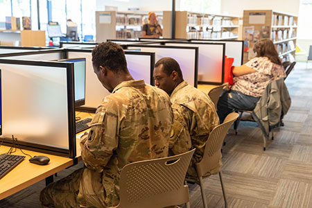 People work on computers at the library