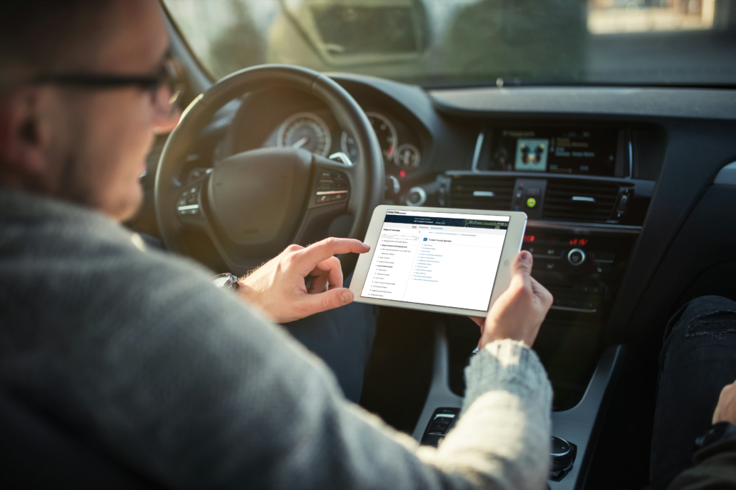 person looking at Chilton Library on tablet in car
