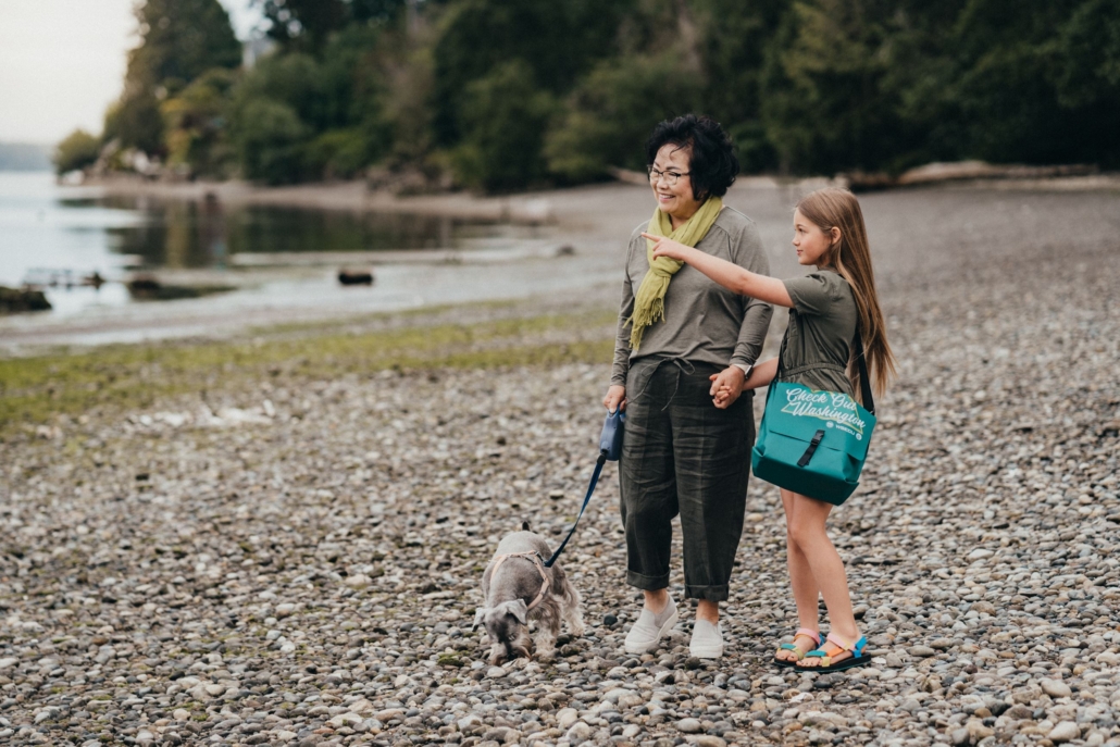 Adult and tween enjoy a state park with their dog